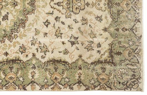 Load image 1 in gallery view. Distressed cream, sage green, and brown rug with a traditional floral medallion pattern and ornate border.