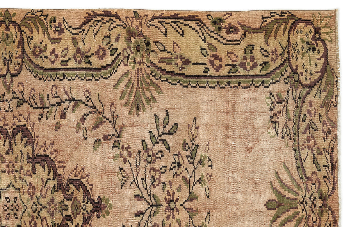 Tan vintage-style rug with a distressed floral border and central botanical motifs in muted green and dark brown.