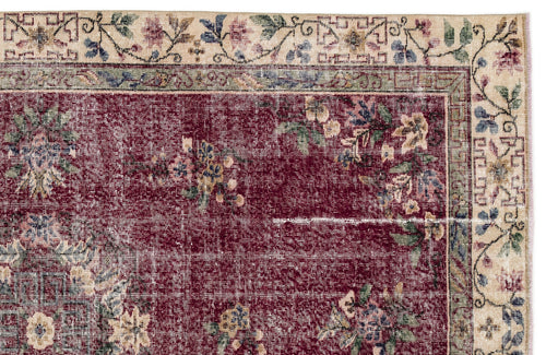 Load image 1 in gallery view. Deep red traditional rug with a distressed floral pattern and a cream border featuring intricate botanical motifs.