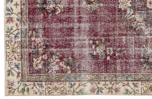 Load image 1 in gallery view. Distressed burgundy rug with a floral pattern and a cream border featuring intricate botanical motifs.