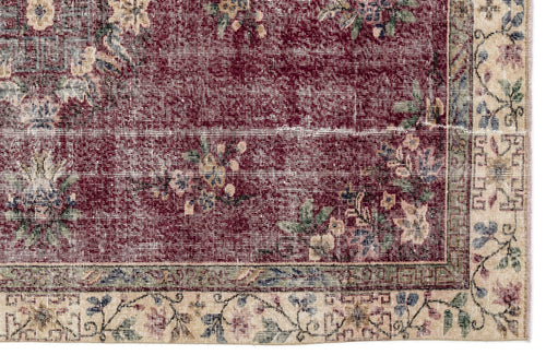 Load image 1 in gallery view. Deep red traditional rug with a distressed floral pattern and a beige border featuring blue and green botanical motifs.