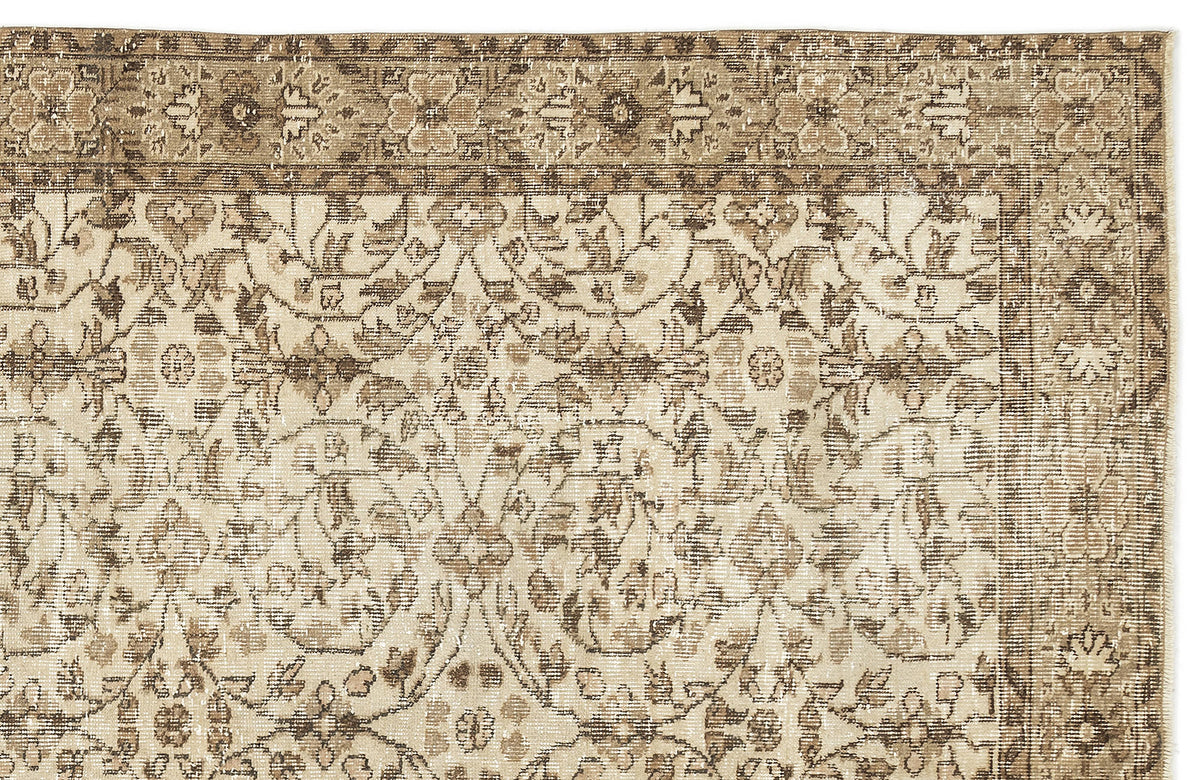 Beige and brown vintage-style rug with a distressed floral medallion pattern and a decorative border.