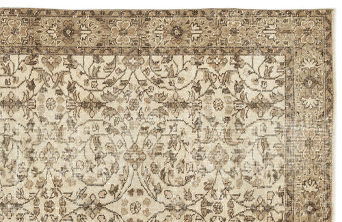 Load image 1 in gallery view. Beige and brown vintage-style rug with a distressed floral medallion pattern and a decorative border.