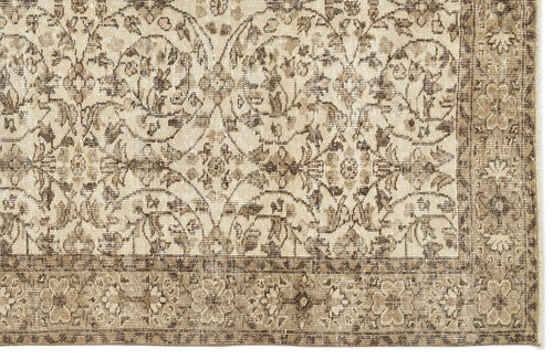 Load image 1 in gallery view. Beige and brown vintage-style rug with a distressed floral medallion pattern and a decorative border.