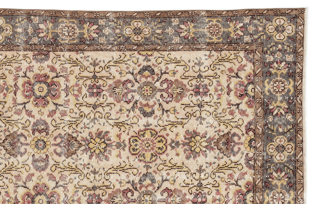 Beige traditional rug with a distressed floral medallion pattern and a dark grey border on a white background.