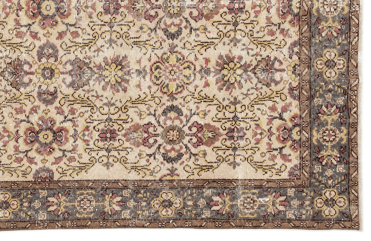 Beige traditional rug with a distressed floral medallion pattern and a dark grey border on a white background.