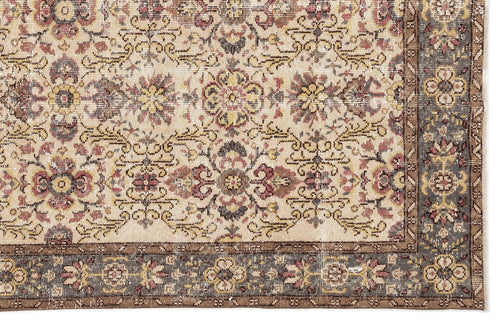 Load image 1 in gallery view. Beige traditional rug with a distressed floral medallion pattern and a dark grey border on a white background.
