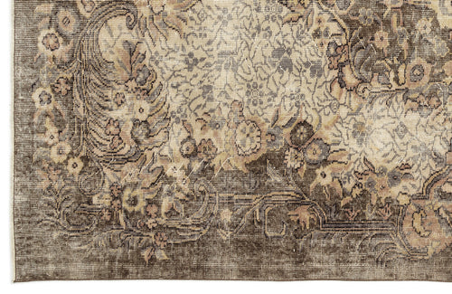 Load image 1 in gallery view. Distressed brown and beige rug with a traditional floral medallion pattern and intricate border detail.