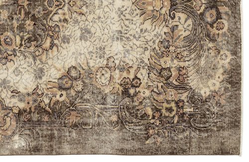 Load image 1 in gallery view. Distressed brown and cream rug with a faded traditional floral medallion pattern.