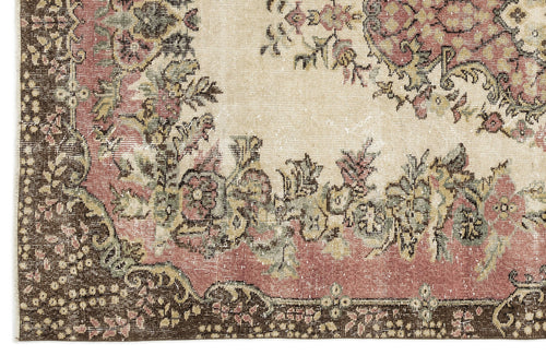 Load image 1 in gallery view. Distressed traditional rug with a floral medallion pattern in muted pink, sage green, and brown on a cream background.