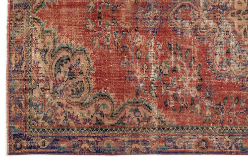 Load image 1 in gallery view. Distressed red rug with a faded traditional floral medallion pattern and a dark blue geometric border.