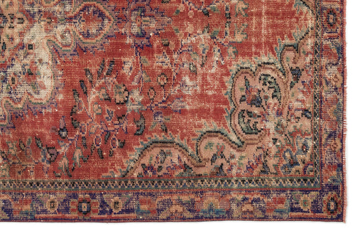 Load image 1 in gallery view. Distressed terracotta, blue, and cream traditional rug with an intricate floral medallion pattern and fringed edge.