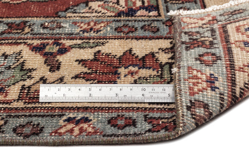 Load image 1 in gallery view. Traditional Persian-style rug with floral motifs in red, blue, and beige, shown with a metal ruler for scale.