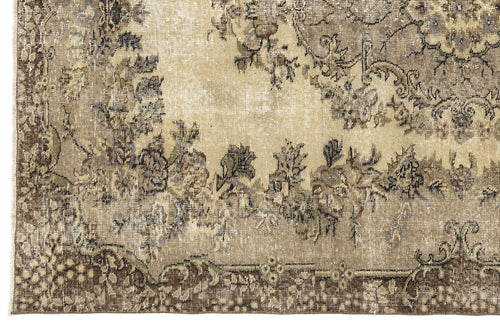 Load image 1 in gallery view. Beige and brown distressed rug with a faded floral medallion pattern and a detailed border.