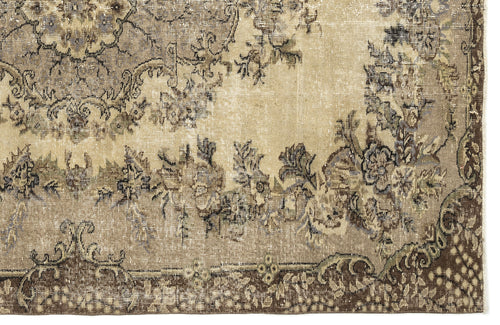 Load image 1 in gallery view. Distressed beige and brown rug with a faded floral medallion pattern and a dark brown decorative border.