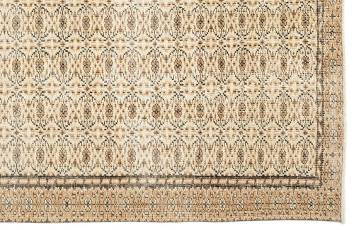 Load image 1 in gallery view. Tan and brown rug with a repeating geometric medallion pattern and a decorative border.