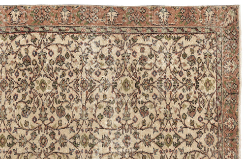 Load image 1 in gallery view. Beige traditional rug with a distressed floral vine pattern in muted terracotta, sage green, and navy blue.
