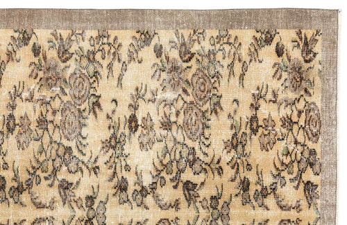 Load image 1 in gallery view. Distressed beige rug with a brown floral pattern and a solid brown border on a white background.