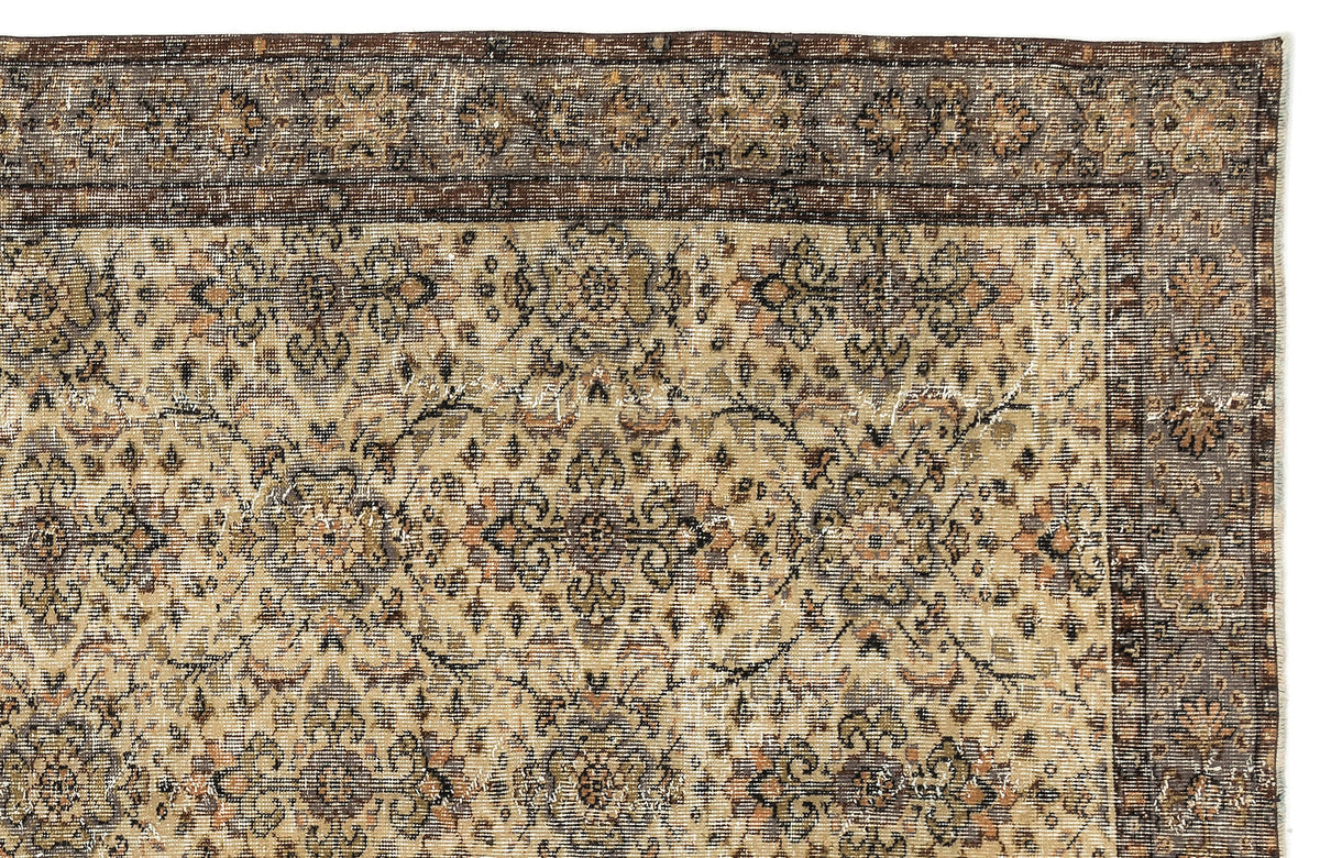 Distressed beige and brown vintage-style rug with a traditional floral medallion pattern and a dark decorative border.