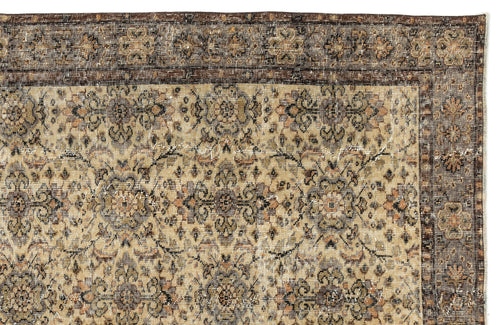 Load image 1 in gallery view. Distressed beige and brown vintage-style rug with a traditional floral medallion pattern and a dark decorative border.
