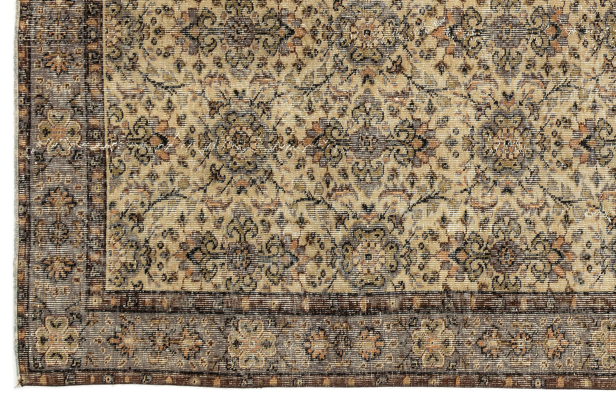 Beige and brown traditional rug with a distressed floral medallion pattern and a detailed geometric border.