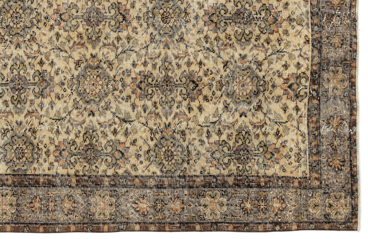 Beige and charcoal traditional rug with a distressed floral medallion pattern and a dark decorative border.