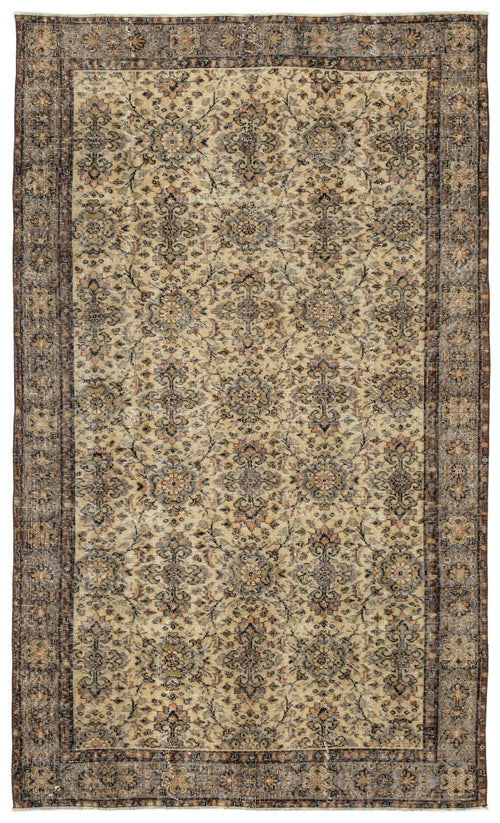 Load image 1 in gallery view. Distressed beige and brown traditional rug with a repeating floral medallion pattern and a dark bordered edge.