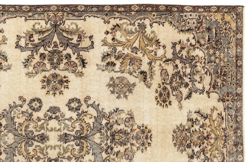 Load image 1 in gallery view. Beige rug with a distressed traditional floral medallion pattern in charcoal, olive, and muted pink tones.