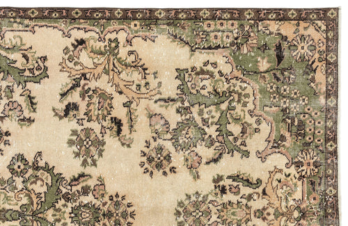 Load image 1 in gallery view. Distressed beige rug with a dark brown border and green and pink floral medallion pattern.