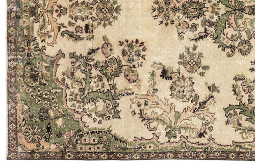 Load image 1 in gallery view. Beige, green, and brown vintage-style rug with a distressed floral medallion pattern and a dark border.