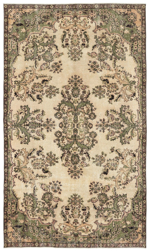 Load image 1 in gallery view. Distressed beige rug with a central floral medallion and ornate green and brown botanical border.
