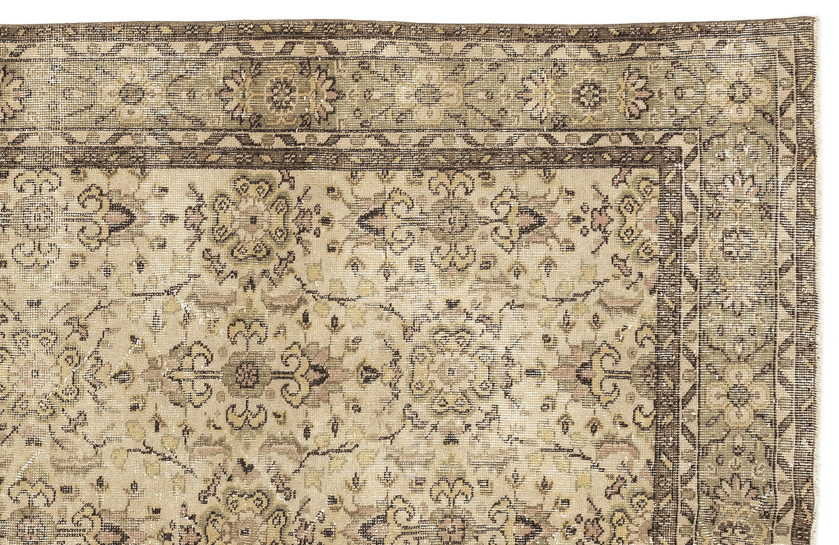 Beige and brown traditional rug with a distressed floral medallion pattern and a geometric border.