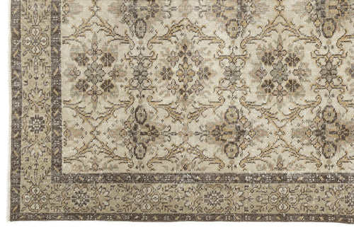 Load image 1 in gallery view. A close-up of the Sadeane Vintage Floral Rug (6'0 x 9'8) showcasing its ornate beige, brown, and taupe floral and geometric patterns with a decorative border along the left and bottom edges.