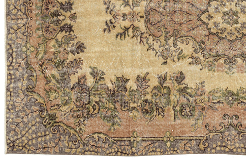 Load image 1 in gallery view. Distressed beige rug with a faded floral medallion pattern in muted green, brown, and charcoal tones.