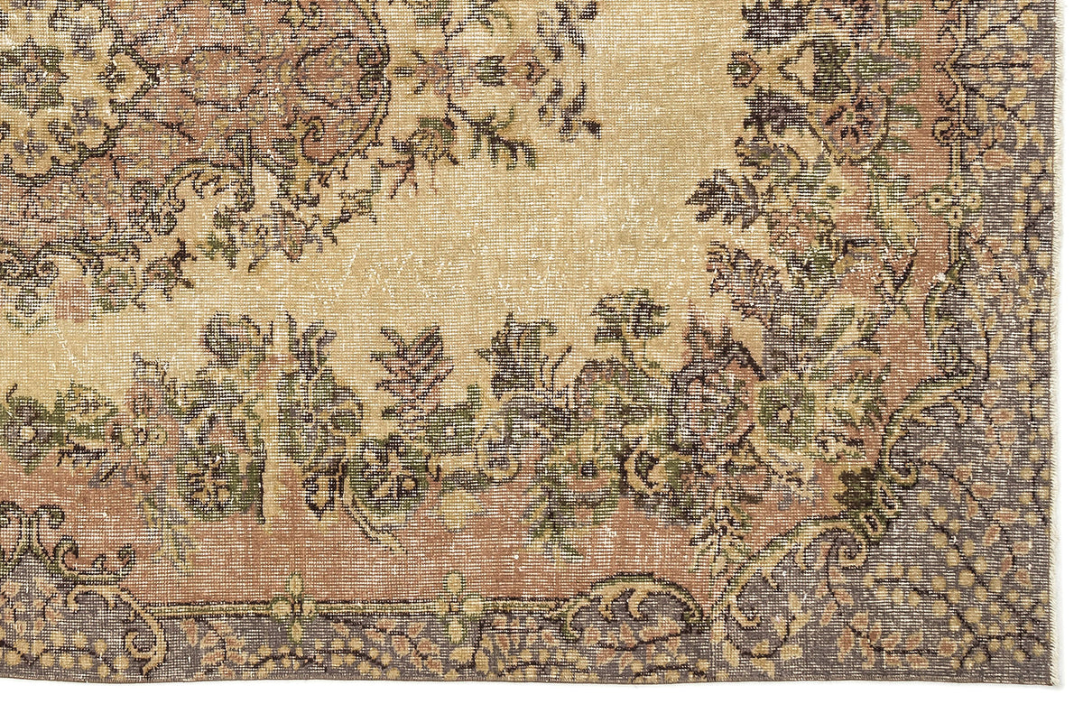 Distressed beige, sage green, and terracotta rug with a traditional floral medallion pattern and dark grey border.