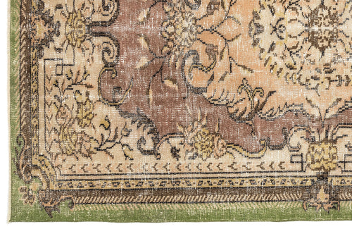 Load image 1 in gallery view. Distressed brown, beige, and green vintage-style rug with an ornate floral medallion pattern and a decorative border.