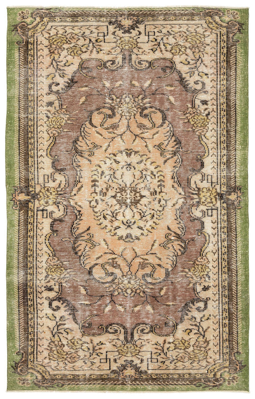 Load image 1 in gallery view. Distressed brown, beige, and green traditional rug with a central floral medallion and ornate geometric border.