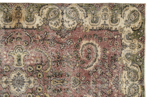 Load image 1 in gallery view. Distressed terracotta, sage green, and cream rug with a traditional floral medallion and paisley border pattern.