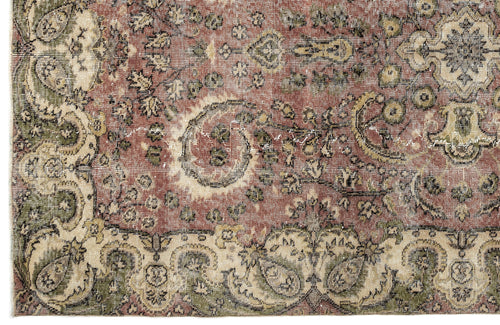 Load image 1 in gallery view. Distressed traditional rug with a faded terracotta, olive green, and cream floral medallion pattern.