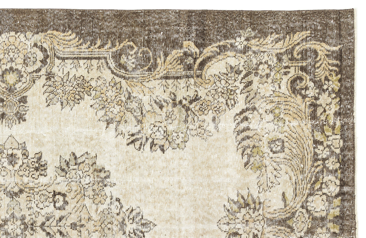 Brown and cream vintage-style rug with a distressed floral medallion pattern.