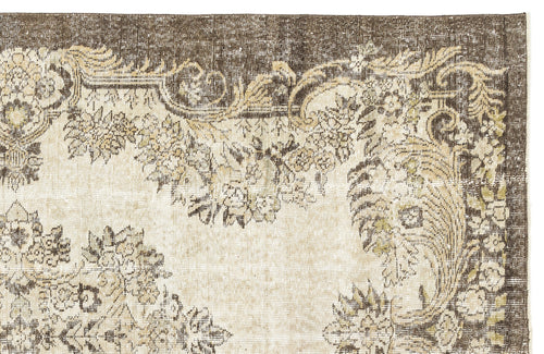 Load image 1 in gallery view. Brown and cream vintage-style rug with a distressed floral medallion pattern.