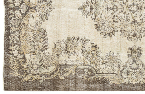 Load image 1 in gallery view. Beige and dark brown vintage-style rug with a distressed floral medallion pattern.