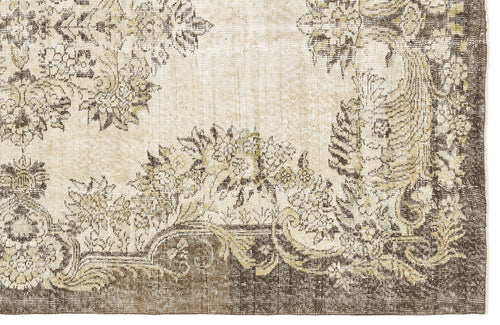 Load image 1 in gallery view. Beige and dark brown rug with a distressed, traditional floral medallion pattern.