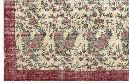 Load image 1 in gallery view. Cream rug with a distressed floral pattern in red, green, and grey, featuring a solid red border.