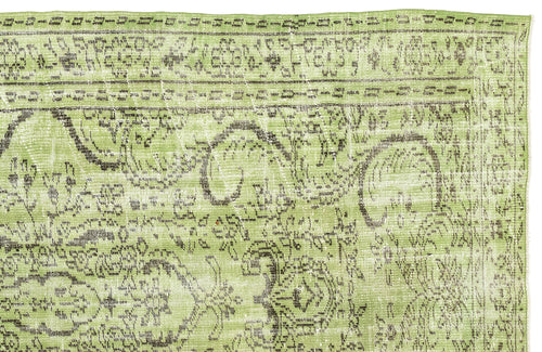 Load image 1 in gallery view. Light green distressed rug with a dark brown traditional floral medallion pattern on a white background.