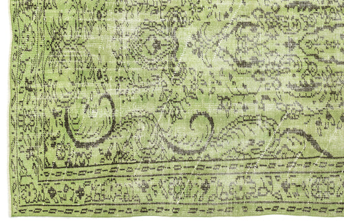 Load image 1 in gallery view. Sage green distressed rug with a dark brown traditional floral medallion pattern and a geometric border.