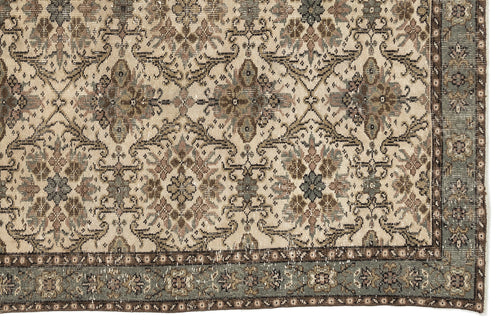 Load image 1 in gallery view. Beige and sage green traditional rug with a distressed floral medallion pattern and a decorative border.