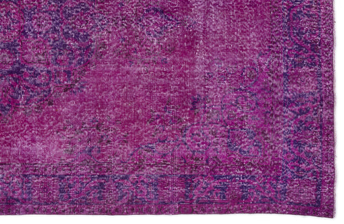 Load image 1 in gallery view. Magenta and deep purple distressed vintage-style rug with a faded traditional floral medallion pattern.