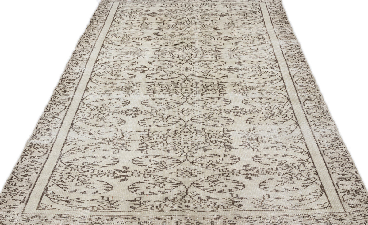 The Greunoa - Vintage Floral Rug (5'4 X 9'6) is a long, rectangular Anatolian runner with a beige background, adorned with intricate symmetrical floral and geometric patterns in brown tones, and finished with a decorative border.