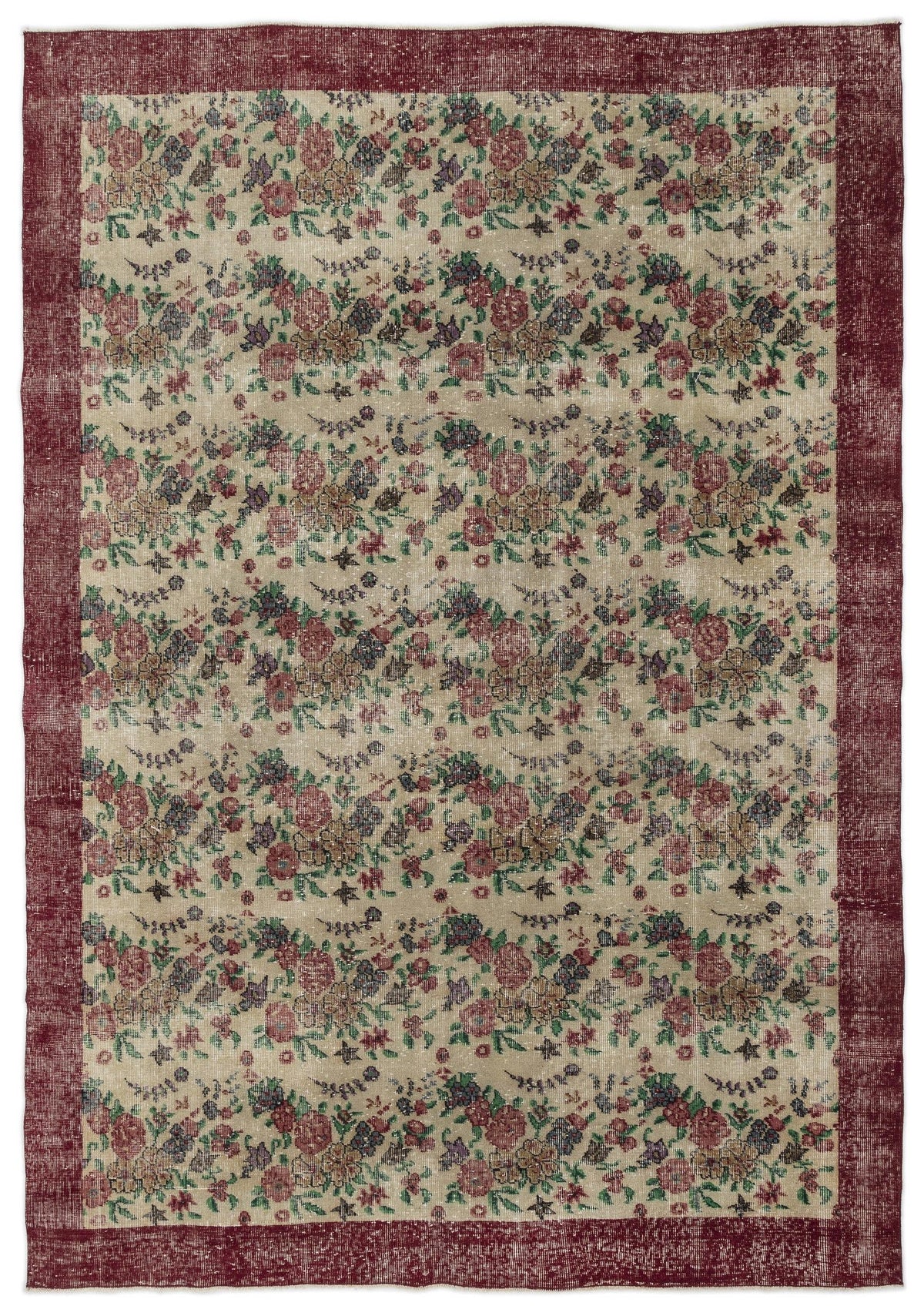 Distressed beige rug with a repeating floral pattern in red, green, and purple, framed by a wide, solid red border.